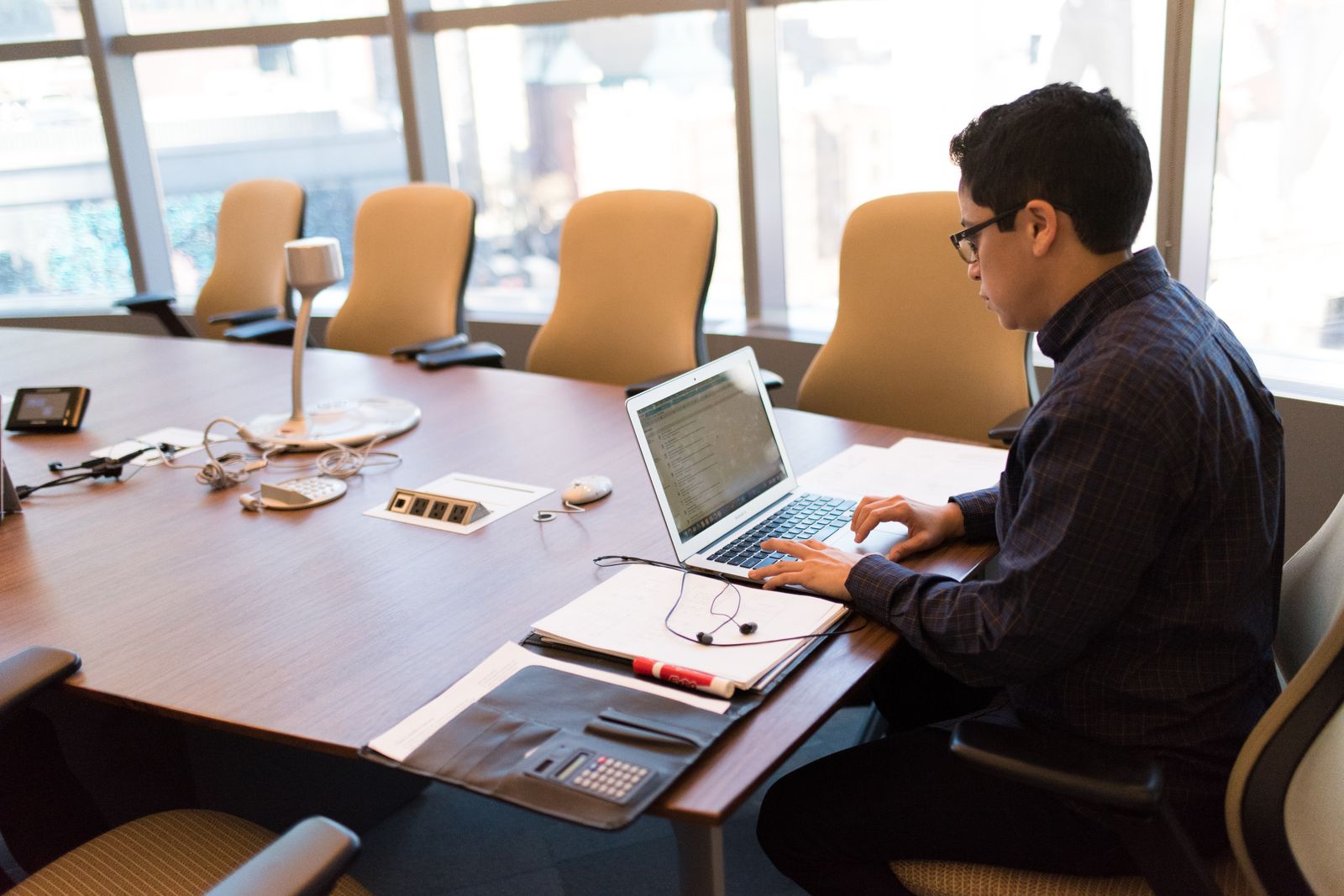 A developer working at a laptop in a meeting room