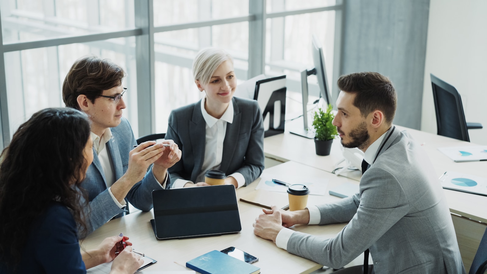 A team meeting around a table in an office